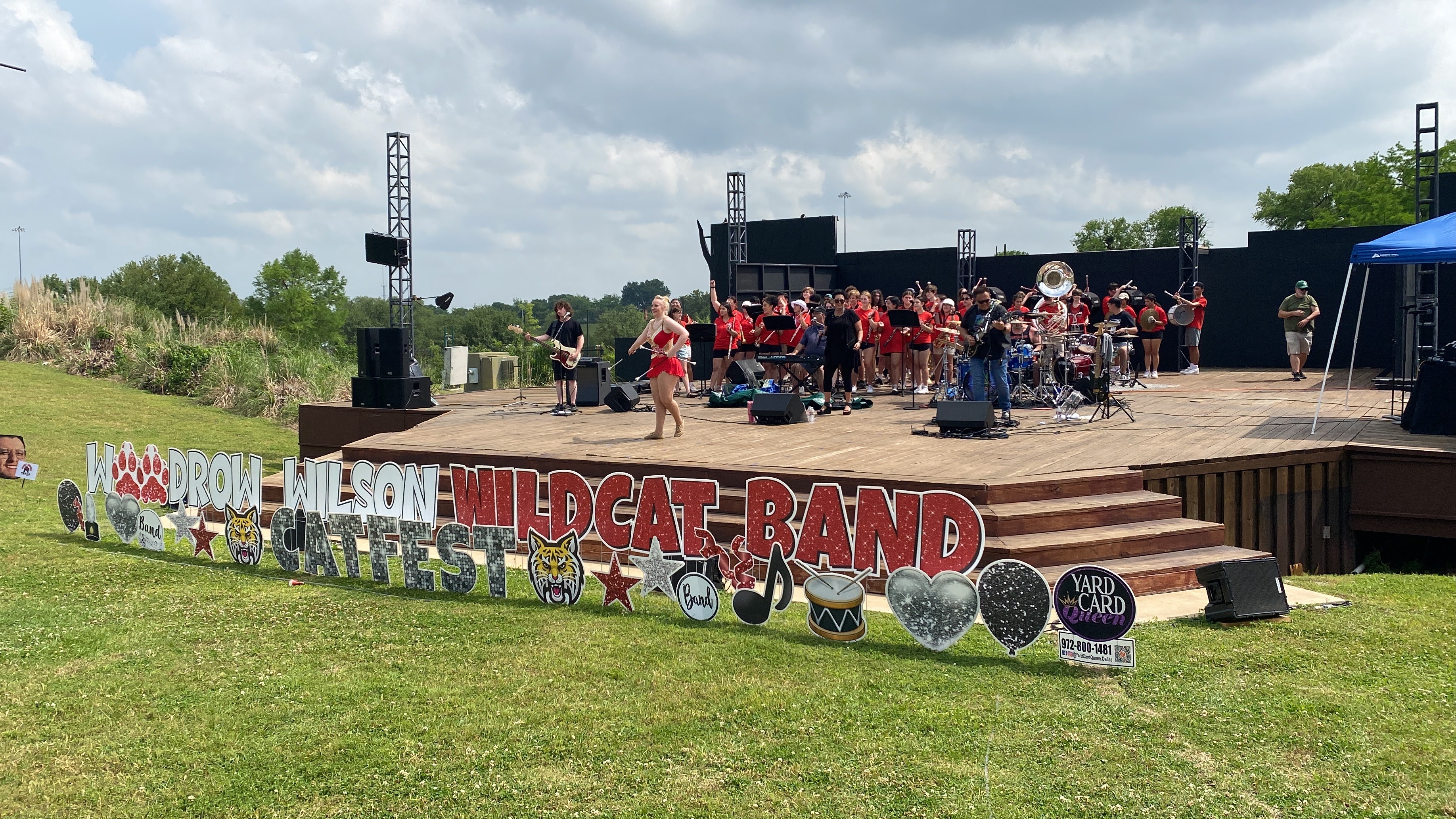 Band on stage with signage